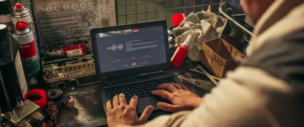 a farmer working on MyKUHN on his computer